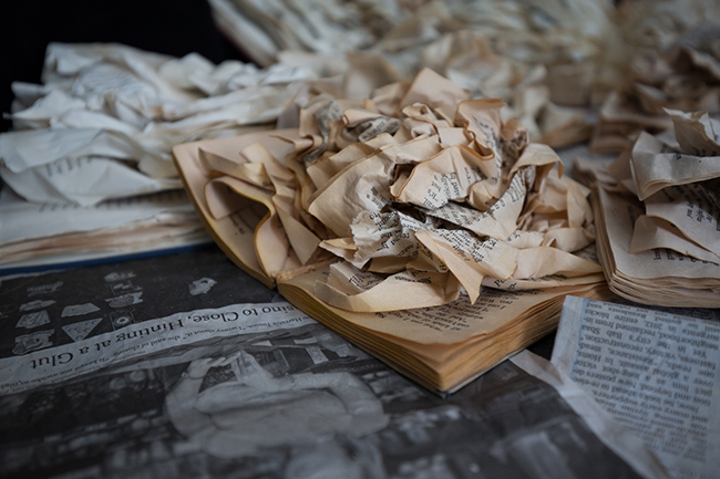 A close-up of a pile of newspapers and shredded book pages. 