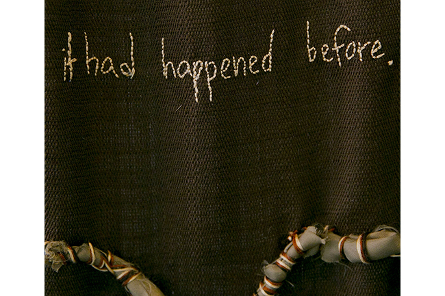 Stitching on a brown background that reads "it had happened before."
