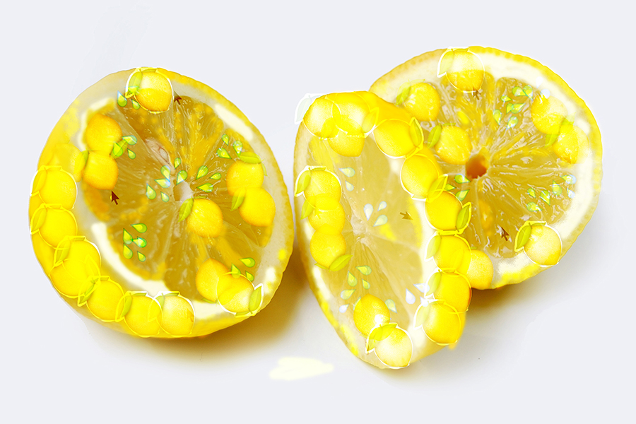 A lemon, cut into three sections, decorated with lemon and water emojis, giving it a glisten. 