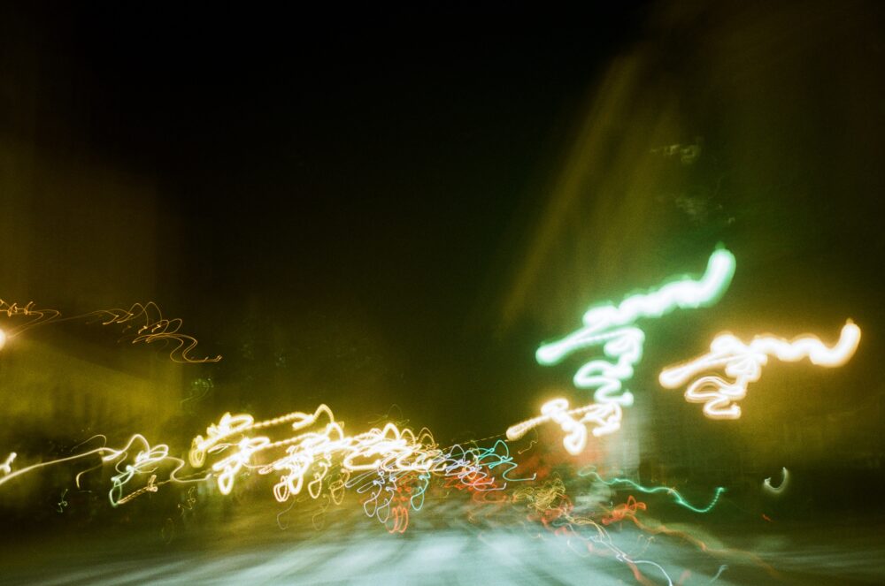 Photograph depicting street lights that have been obscured due to motion blur