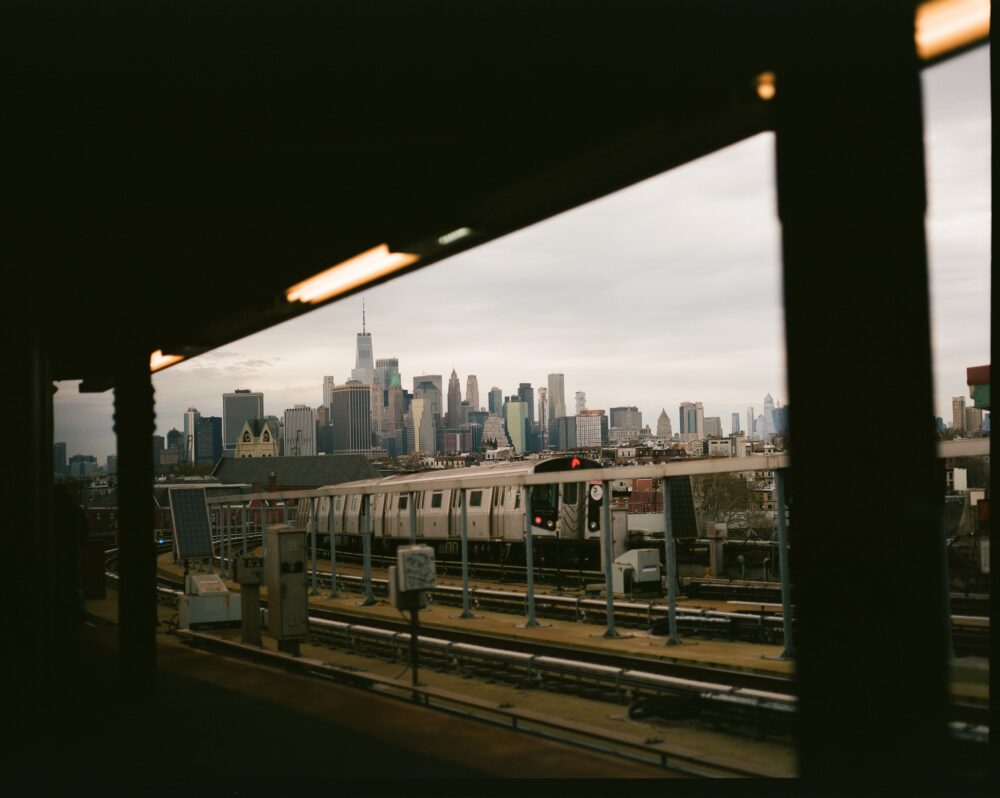 Photograph depicting the Smith-9th Street F Train stop with the Manhattan skyline in the background