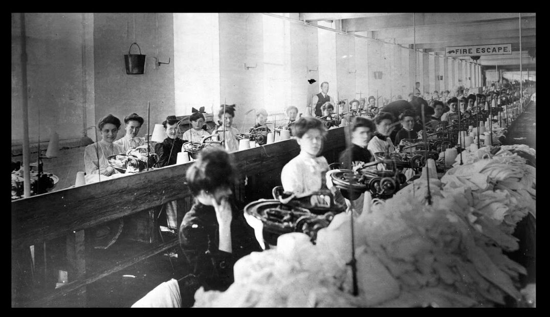 Archival photograph of women working in rows in a textile factory