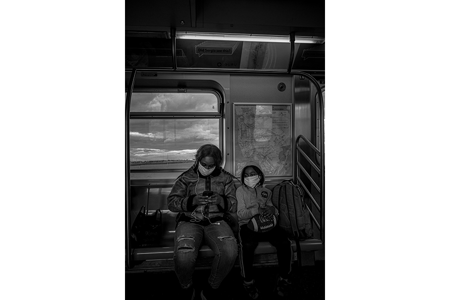 Little girl and her mother sitting together on the A train