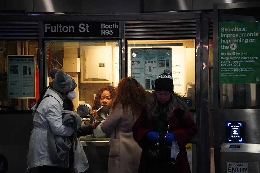 A family clustering at the Fulton station booth