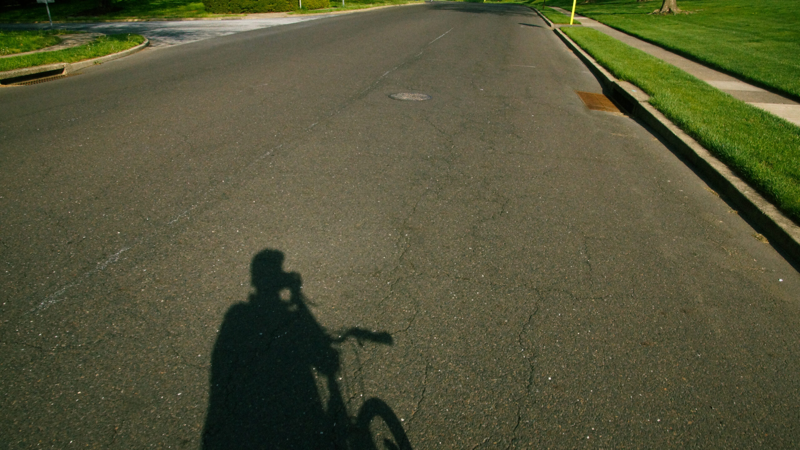 A self portrait depicting my shadow as I ride a bike around my neighborhood taking photographs.