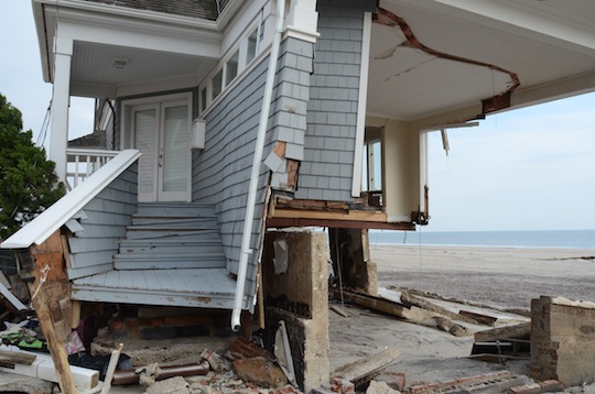 A side-view of a devastated house on the beach. 