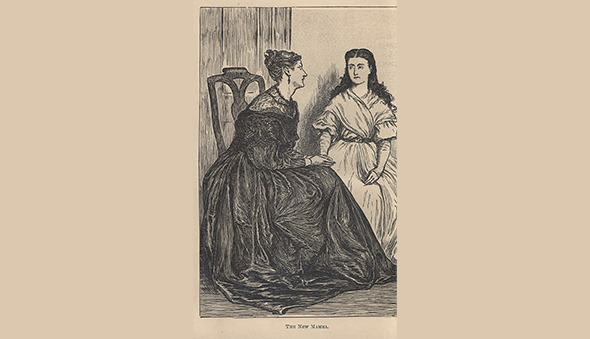Two women sit and hold hands