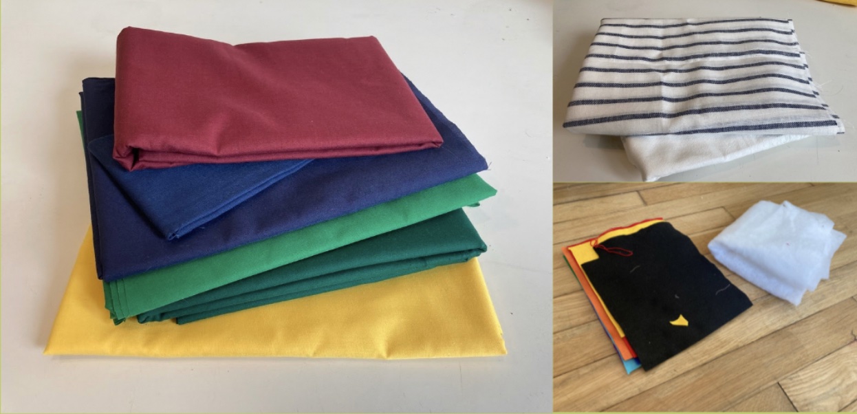 A stack of yellow, dark and light green, dark and light blue, and red quilting fabric.