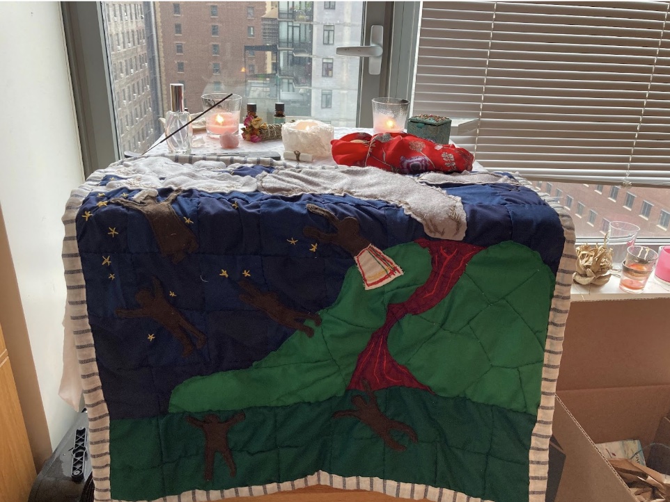 A view of the Blessing Ceremony from further back, showing the entirety of the finished quilt.