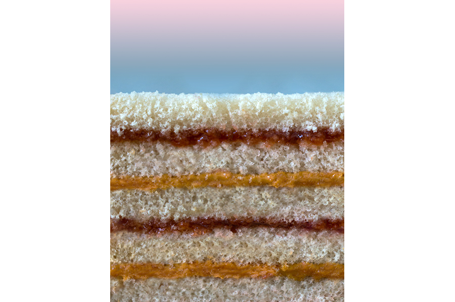 Close-up of the side of a stack of layered peanut butter and jelly sandwiches. 