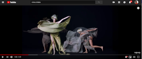 A screengrab from "Mine," by Beyonce, a music video featuring dancers wearing etherial beige, gray and mauve gowns sway and fall in slow motion.