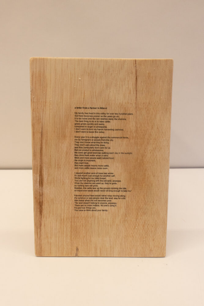 Wood panel with the author's "A Letter From a Farmer in Niterol" printed on with black ink. 