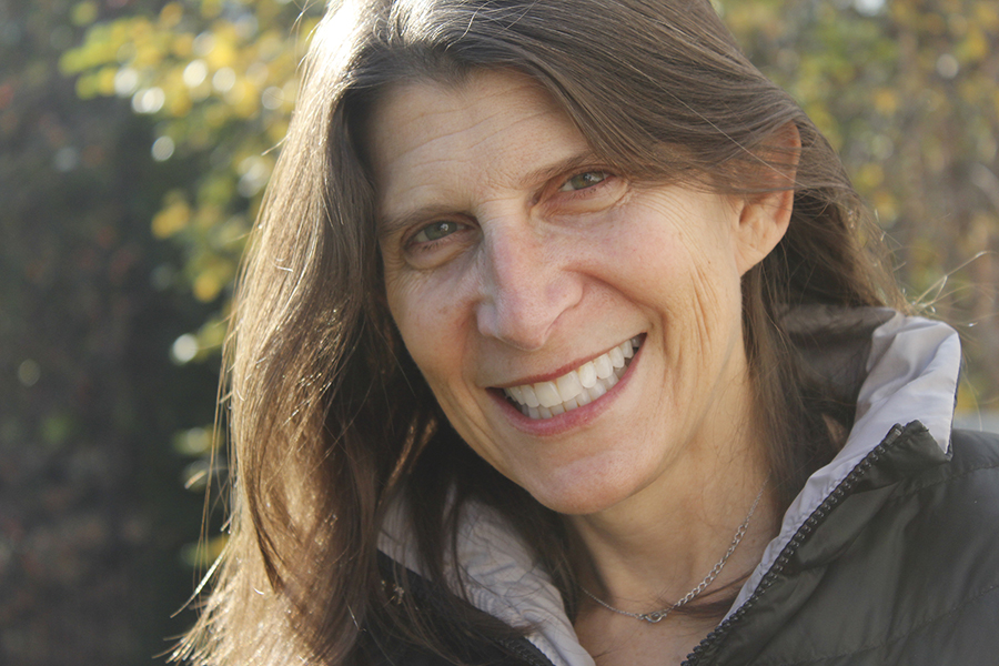 Photo of woman smiling, verdant background