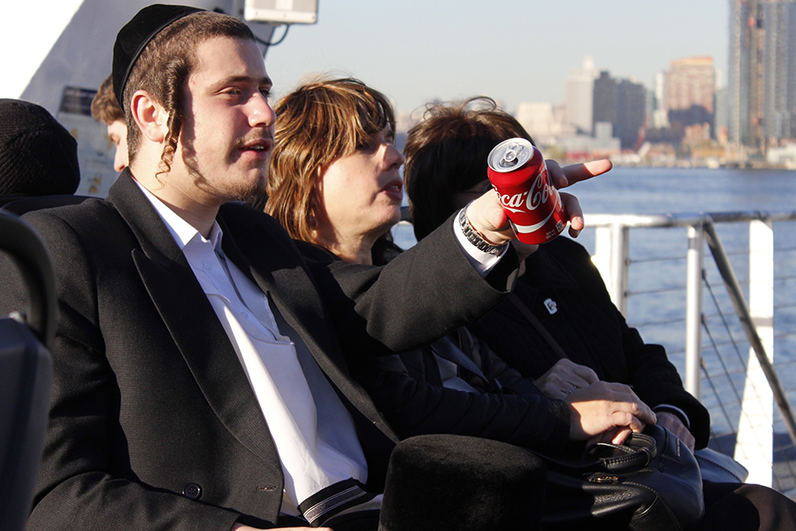 Three people seated on a ferry in profile