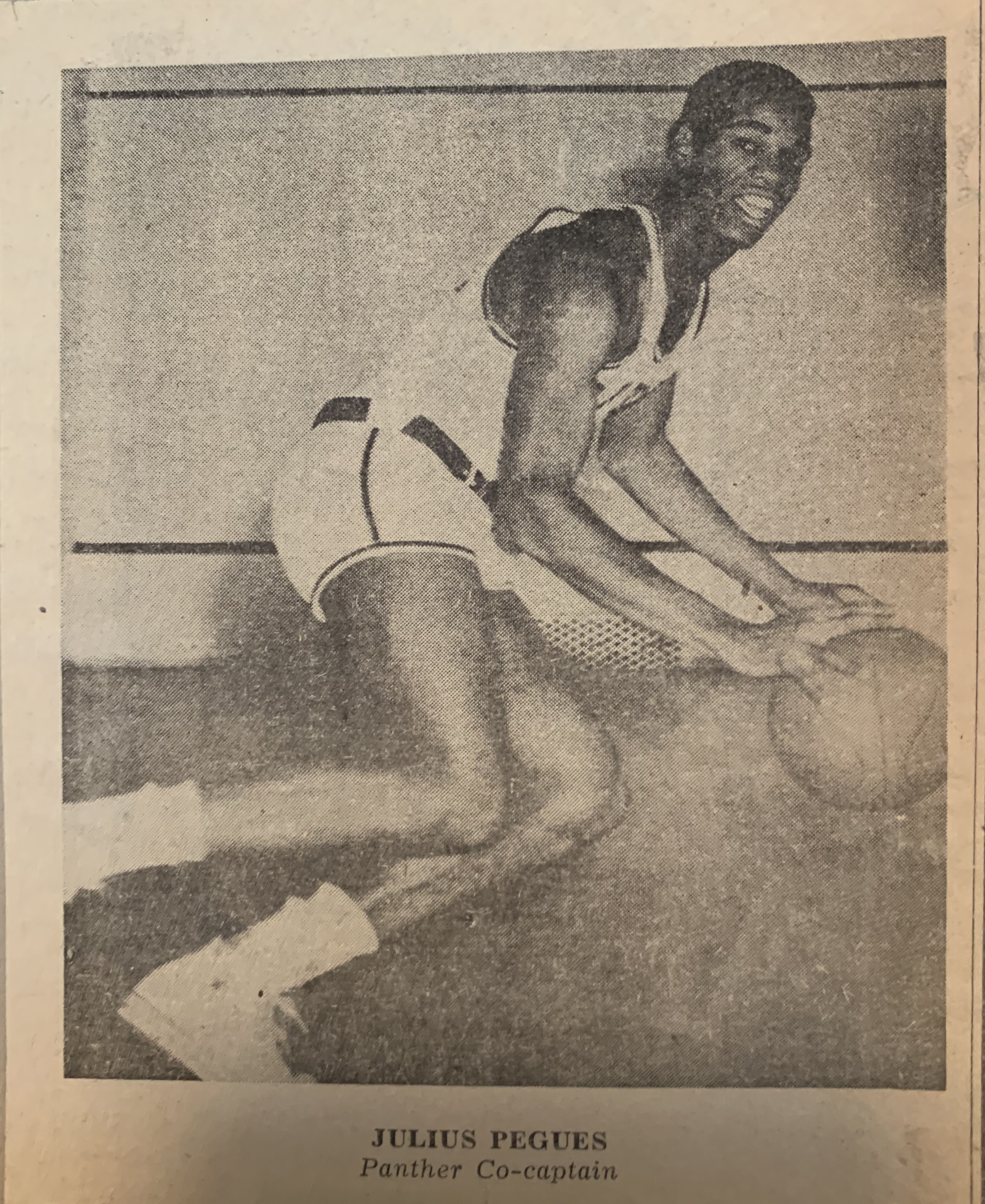 News clipping: A black-and-white photograph shows Julius Pegues dribbling a basketball in profile, face turned toward camera
