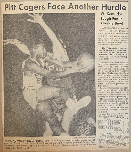 Newspaper clipping from an article about a Pitt victory over Seaton Hall, with an action image of Pegues jumping, ball in hand, while an opponent attempts to block