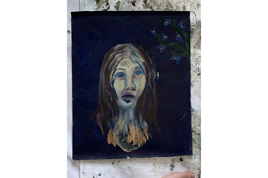 Painting: light-blue flowers coming from the right side of the canvas, girl’s head centered in the middle on navy blue background.