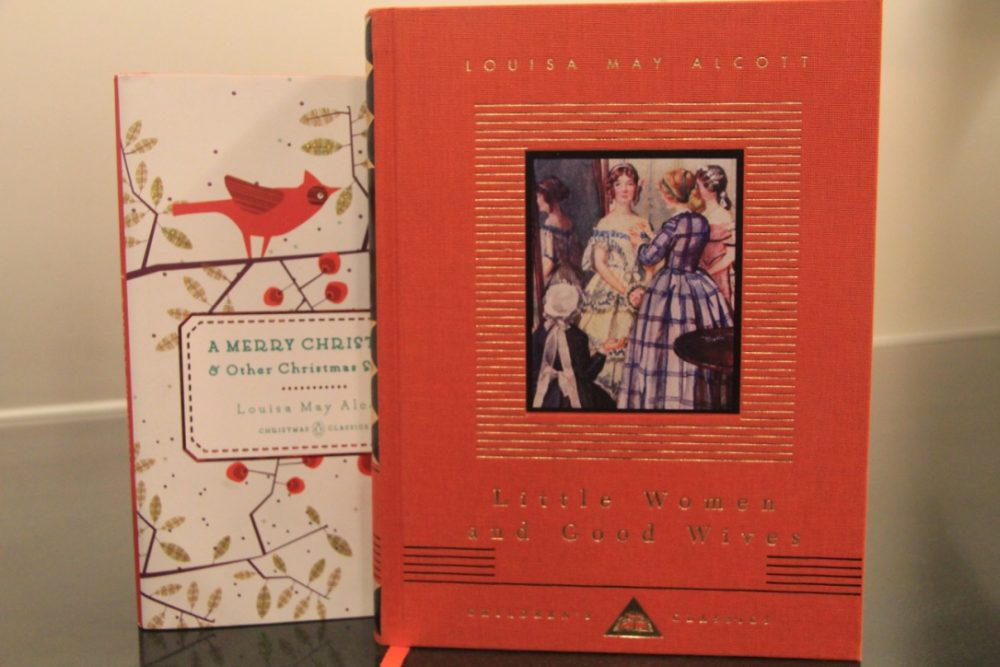 A hardbound copy of "Little Women" and "A Merry Christmas," stood on a table. 