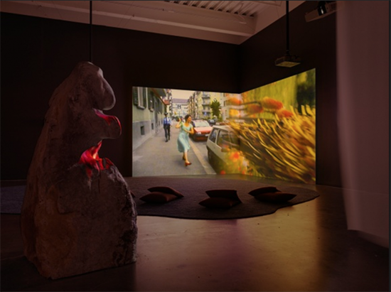 A room filled with beanbags, projecting colorful footage on a large wall.