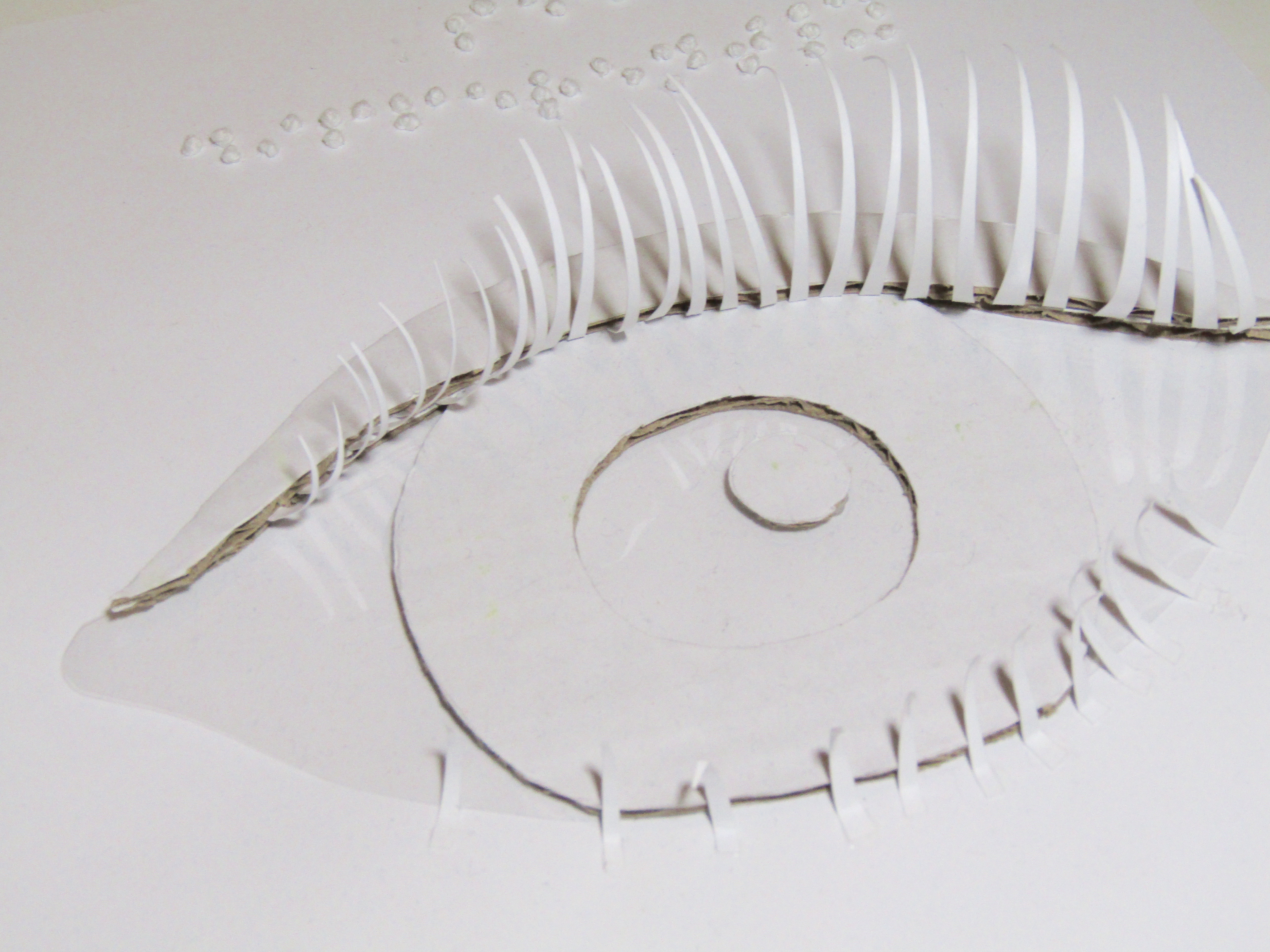 Close-up of the cut-out eye, complete with eyelashes and a pupil.