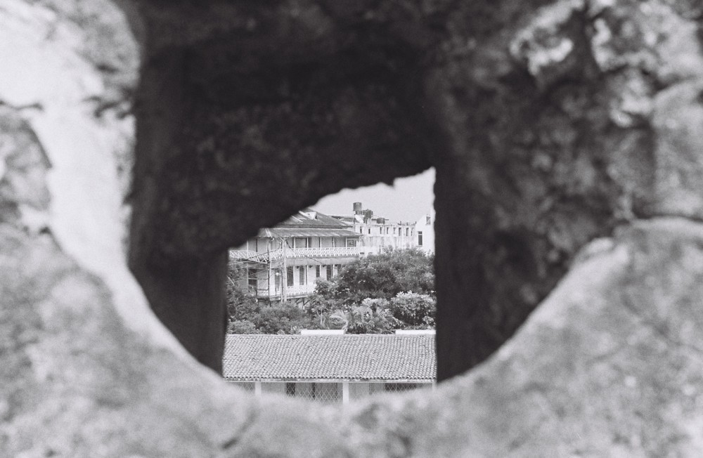 View of living complexes from through a hole in rock. 