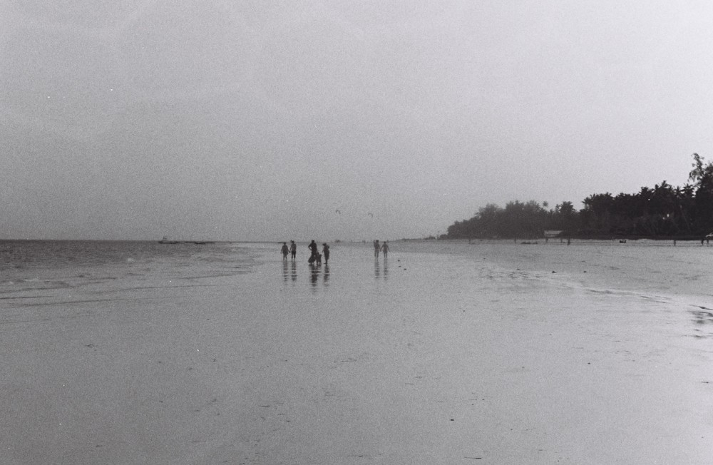 Figures in the distance on a foggy beach. 