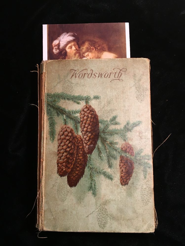 Poems of Wordsworth with a bookmark with an older-style portrait. 