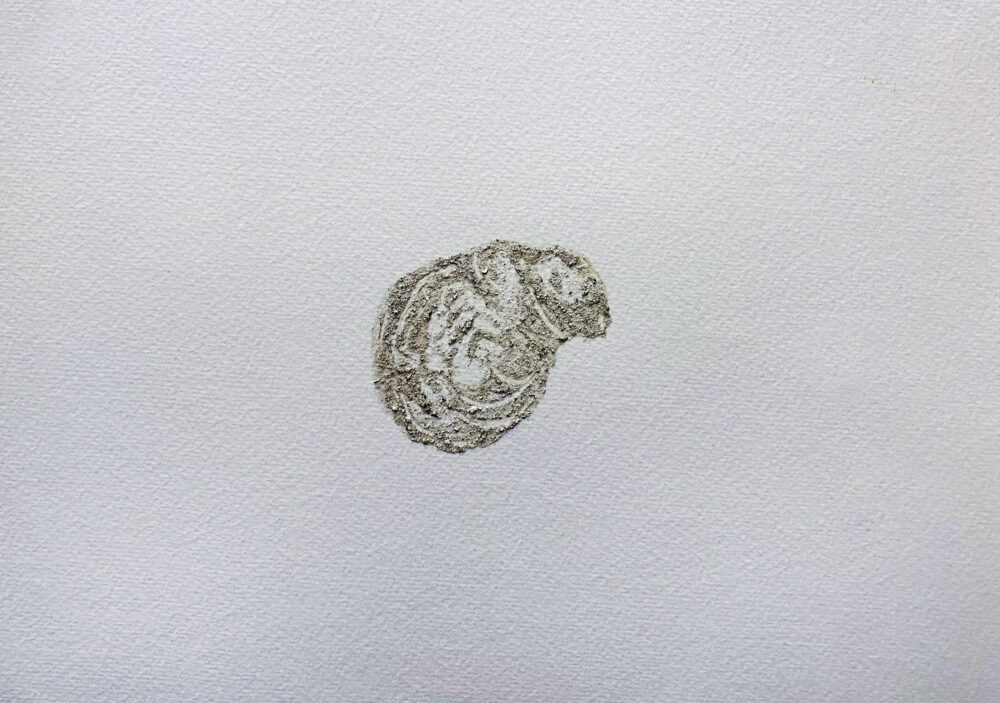 Light brown organic shape. Resembles a square with very rounded edges, the right side angled left. Edges are bumpy, not straight. Watercolor has granules in some areas, mainly on the right side. Paint is very sparing leaving many spots open to the page.
